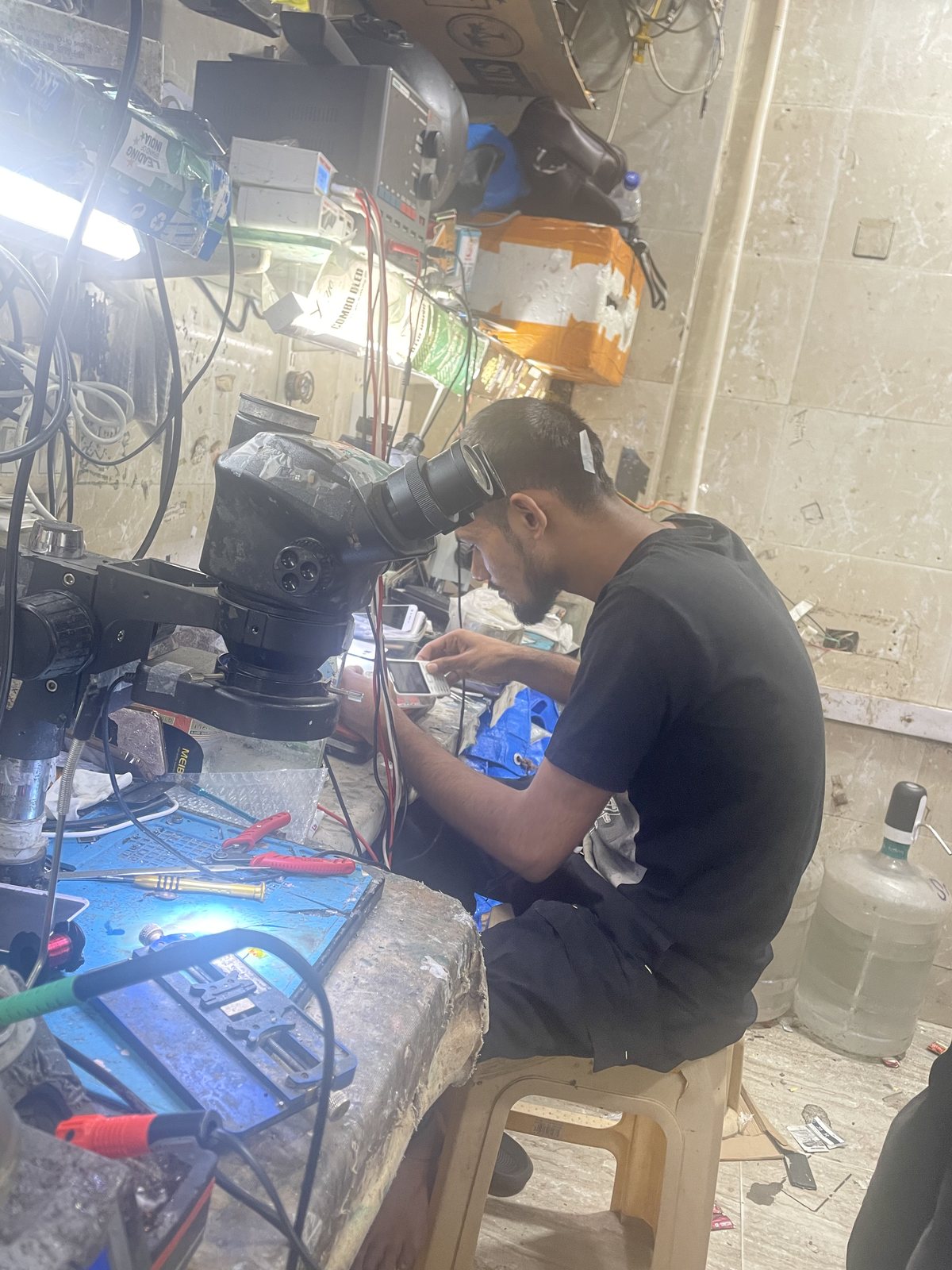 An Apex52 technician repairing electronics at the workbench